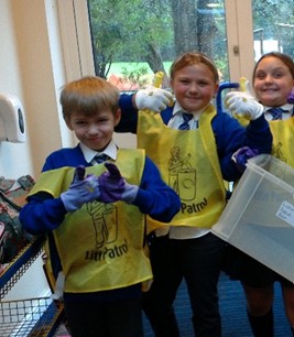 Eco-Warrior Students wearing "Litter Patrol" vests and giving a thumbs up.